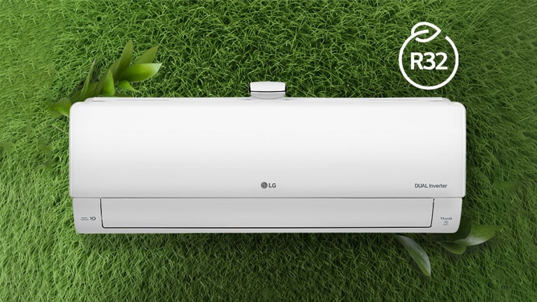 The LG Air conditioner is installed on a wall of grass. The R32 logo for energy efficiency is in the upper right corner.