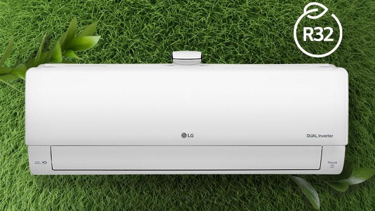 The LG Air conditioner is installed on a wall of grass. The R32 logo for energy efficiency is in the upper right corner.