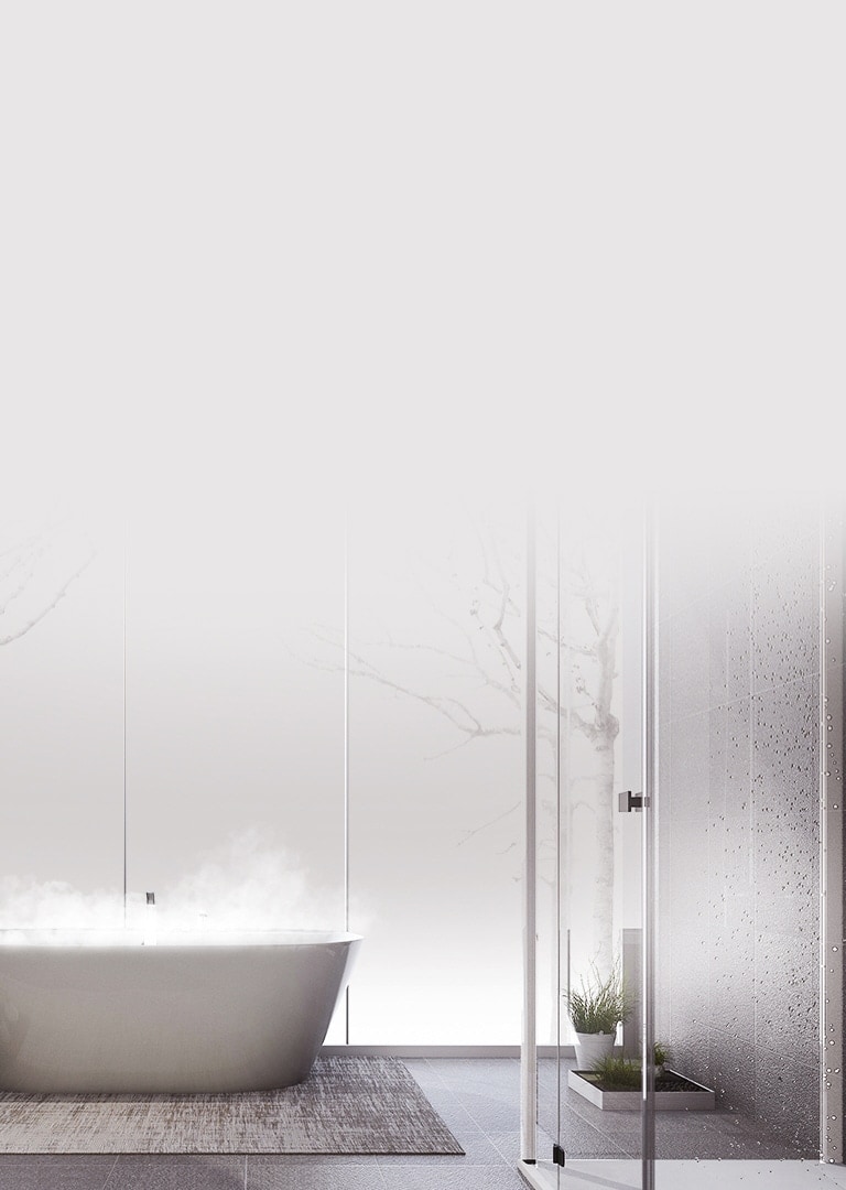 Side view of a steamy bathtub on the left in a shower room, amenities nearby. Small plants grace the right side.