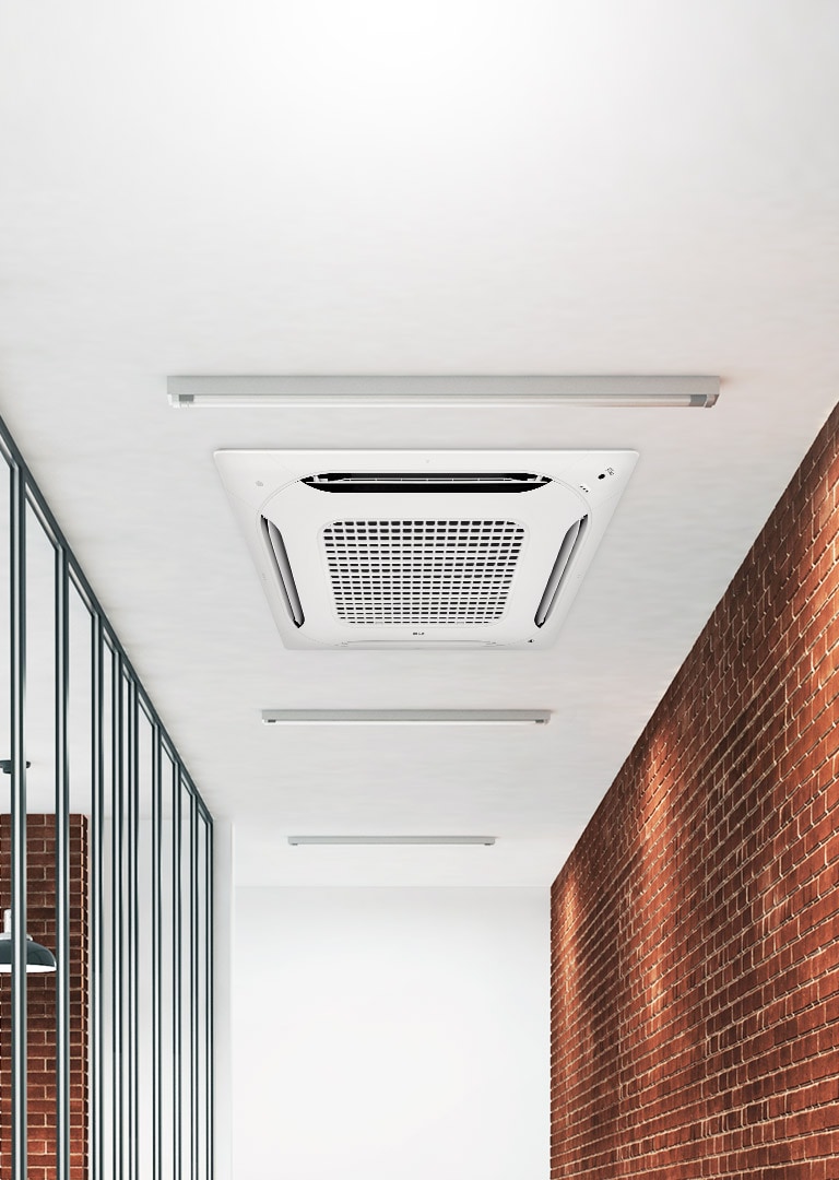 An LG Ceiling Mounted Cassette adorns a sprawling hallway, flanked by light bars and offset by a tastefully decorated red brick wall to the right.