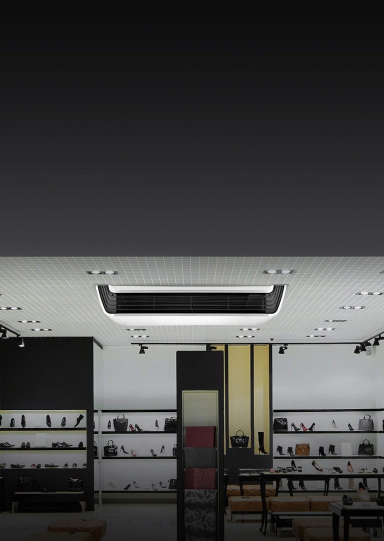 LG Ceiling Suspended unit, featuring a white body with a black front structure, is mounted on the ceiling adorned with a series of lights.