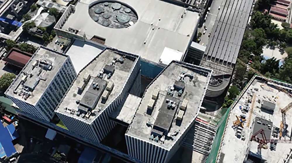 Looking down from above on the rooftops of large buildings.