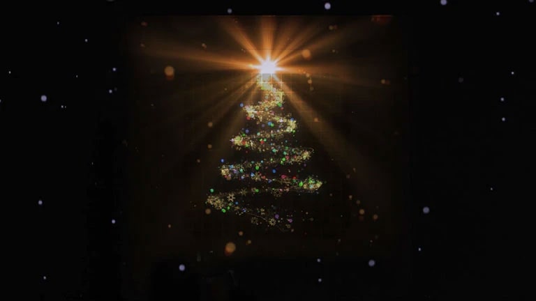 A Christmas tree-like structure is formed from vibrant sparkling particles, topped by a small glowing circle emitting light.