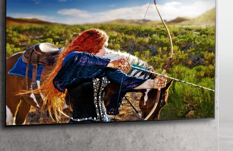 A Nanocell TV is hanging on a wall. On the screen, a medieval archer aims her bow.