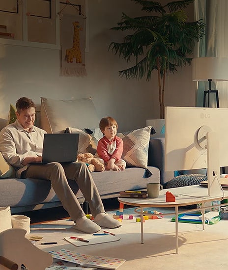 The child plays alone with the LG MyView Smart Monitor, while the father is undisturbed, focusing on work in a video scene.