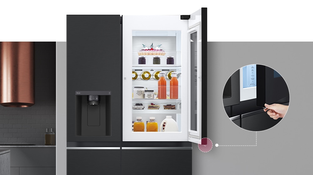 The front view of a black InstaView refrigerator. The door-in-door of the refrigerator is open. There's a small screen that explains where a concealed opening button is to open the door.