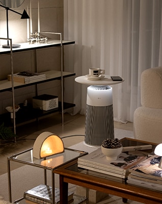 In the middle of the dark living room, the product is placed gently emitting mood lighting. Coffee cups and props are placed on top of the product to serve as tables.