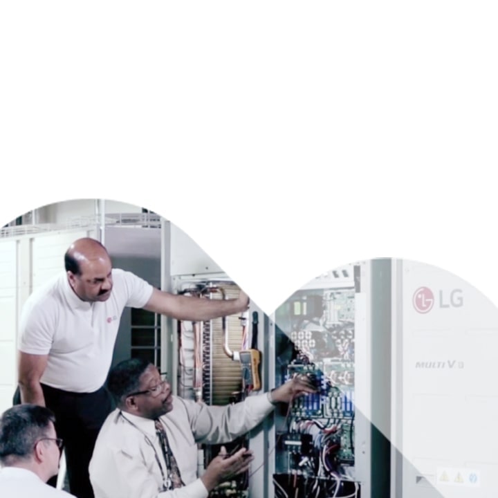 Some experts are inspecting one of the LG MULTI V i machines installed next to the wall, carefully checking its performance and key components.	