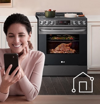 Woman controls oven with smartphone