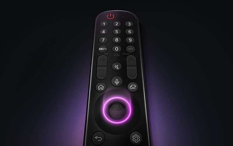An LG Magic Remote with the middle circular button, as neon purple light emanates around the button to highlight them. A soft purple glow surrounds the remote on a black background.