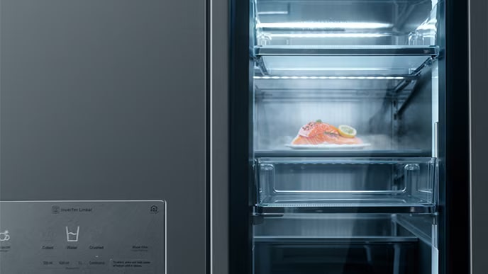 Interface icon of LG SIGNATURE Refrigerator is being carved by a tool on its stainless steel body.