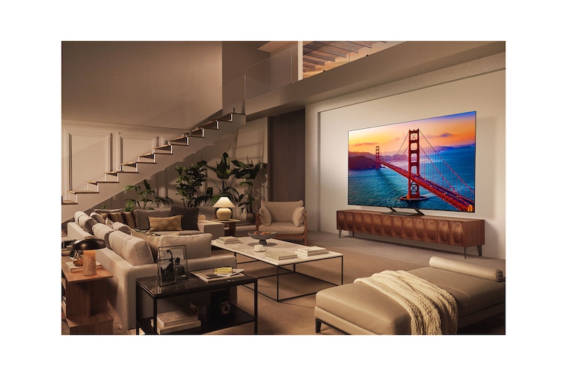 LG AI Magic Remote in front of an LG TV screen. On the screen is a personalized greeting from the LG AI with custom keywords based on the user's search and watch history. By the remote is an icon and label showing that the AI Concierge functionality is easily accessible with one short press on the AI button.