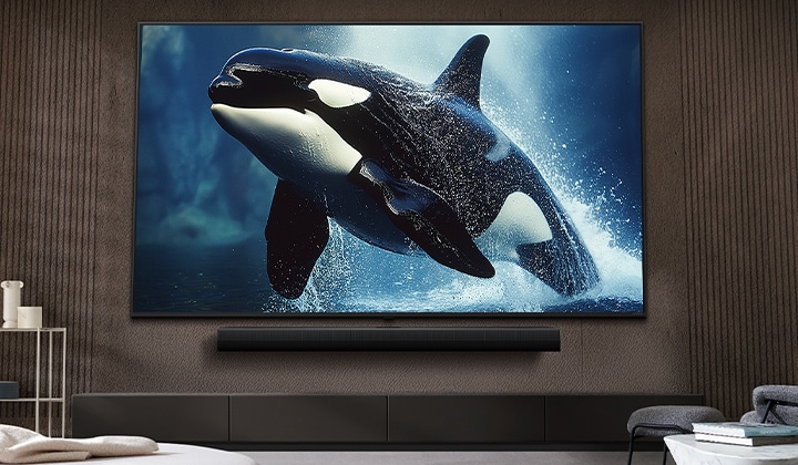 LG TV with an impressively large screen mounted on a wall above a LG Soundbar in a modern style living room.