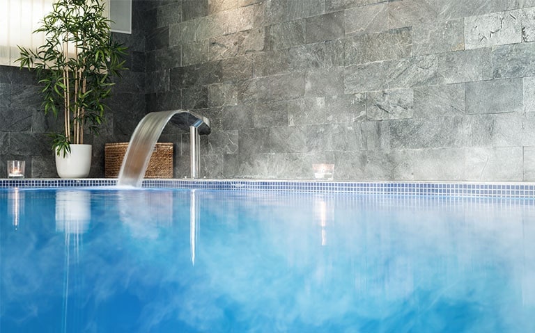 An Image of a hotel spa filled with hot water.
