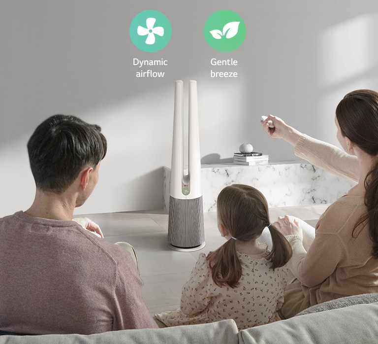 A family sitting on the sofa in the living room is changing the product mode with the product remote control. Above the product, icons expressing 2 modes are shown.