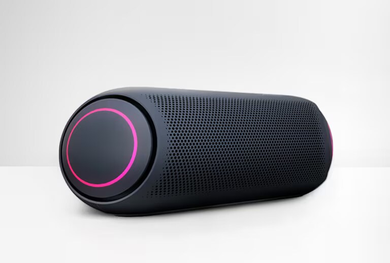 On a white background, a left end view of LG XBOOM Go PL5 is showing magenta lighting.