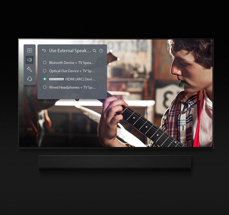 An image of an LG OLED TV with Soundbar. A video of a boy playing the guitar plays on screen with Soundbar Mode's settings overlayed on top.