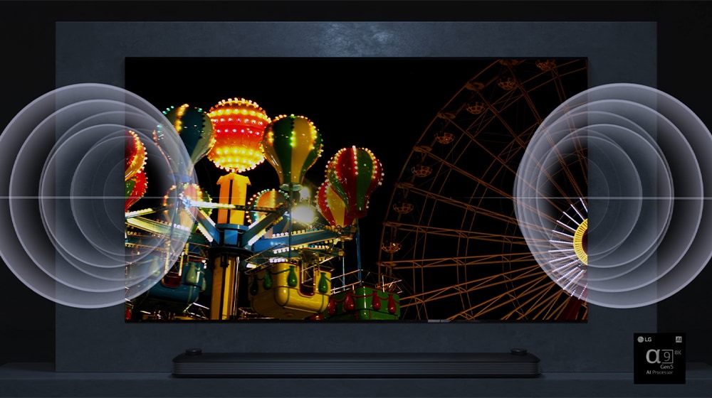 A TV screen shows a very bright Ferris wheel in night and there is a visual effect of sound on left and right side of a TV. 