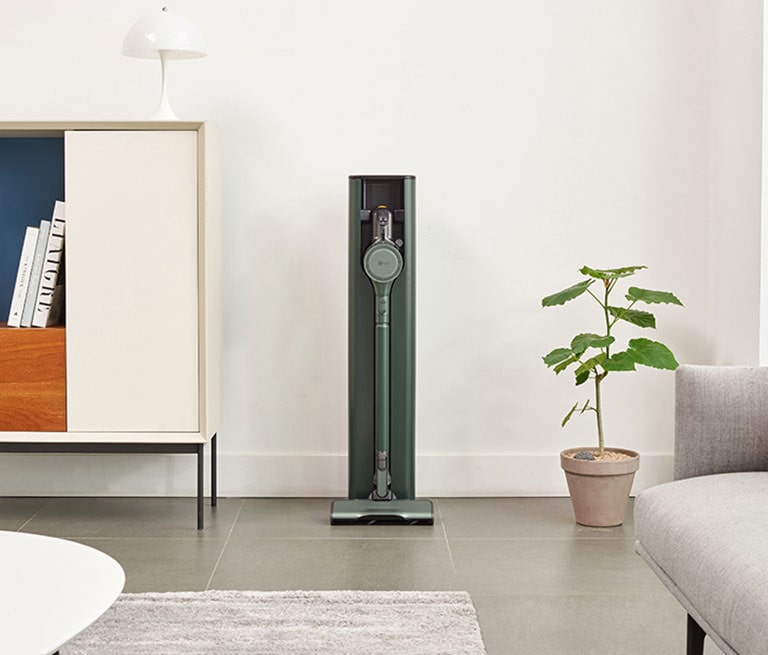 It shows calming green color LG CordZero All-in-One Tower Objet Collection is placed in the Living Room that matches naturally to the furniture around.