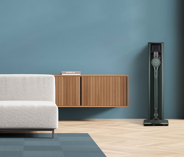 It shows calming green color LG CordZero All-in-One Tower Objet Collection is placed in a blue-tone modern living room.