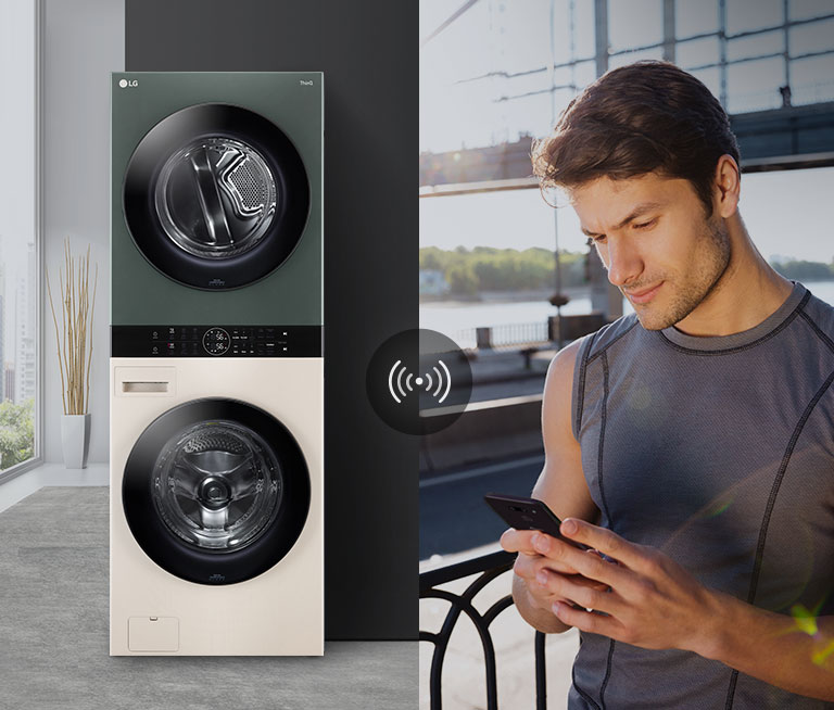 A man outdoors is checking the condition of the WashTower at home via the LG ThinQ app.