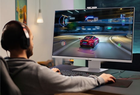 A man enjoys gaming in his personal space, undisturbed by other family members, with the LG MyView Smart Monitor without a PC.