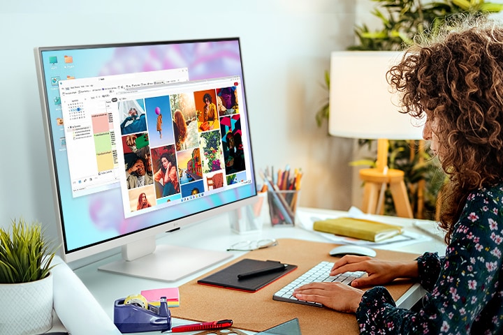 Adjusting the LG MyView Smart Monitor, placed on the desk, to a comfortable angle at eye level for convenient usage.