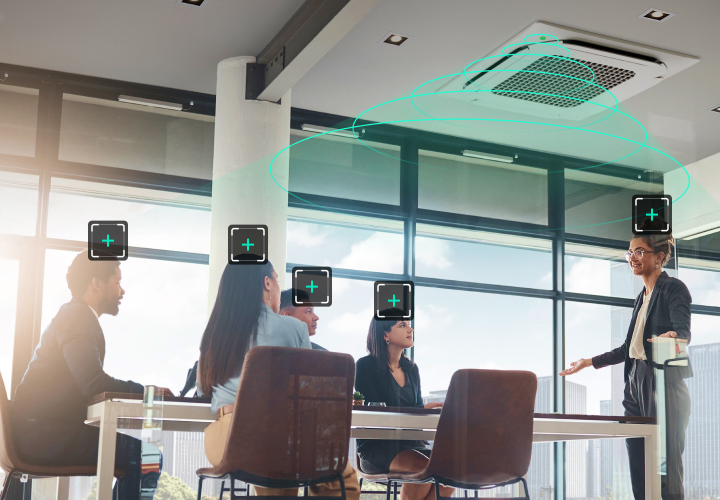 A modern office meeting room with an LG ceiling-mounted cassette uses human detection sensor technology to detect and direct airflow toward individuals.