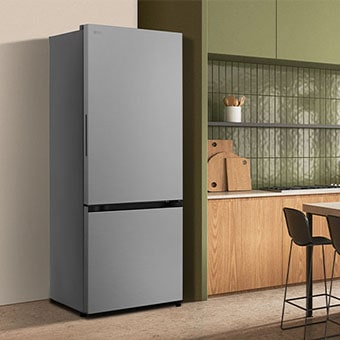 A modern lg black bottom freezer refrigerator with water dispenser is seamlessly fit next to a wooden kitchen countertop.