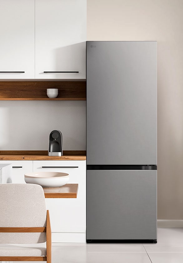 The side view of lg bottom freezer refrigerator with water dispenser with green cabinets and a stylish island.