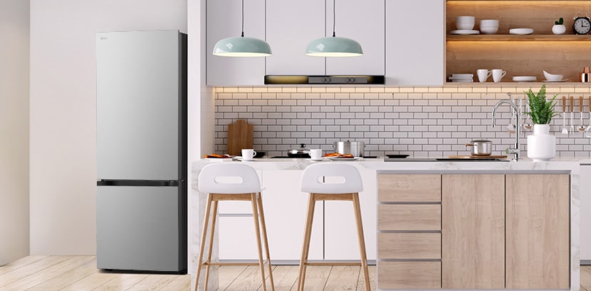 The side view of lg bottom freezer refrigerator with water dispenser with green cabinets and a stylish island.