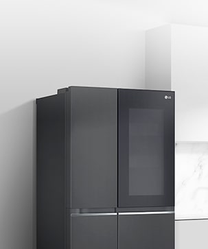 A side view of a kitchen with a black InstaView refrigerator installed.