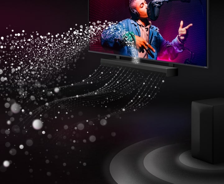 LG Soundbar and LG TV in a black room playing a musical performance. White droplets representing soundwaves shoot upwards and forward from the soundbar. A subwoofer is creating a sound effect from the bottom.