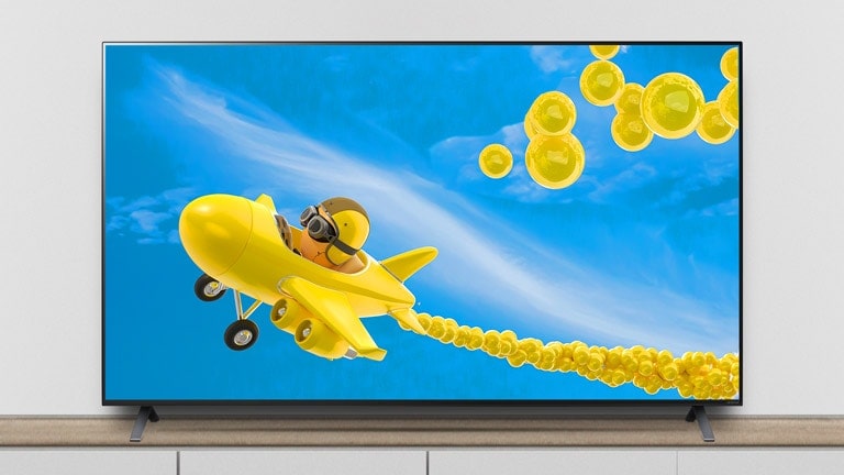 The TV is on the stand, and the screen shows an animation of an airplane flying through it.