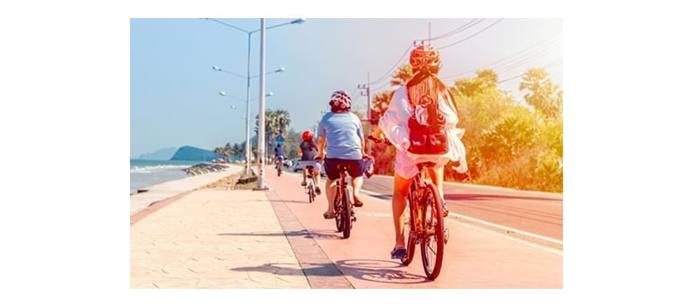 ผู้คนขี่จักรยานไปตามชายหาดปราณบุรี