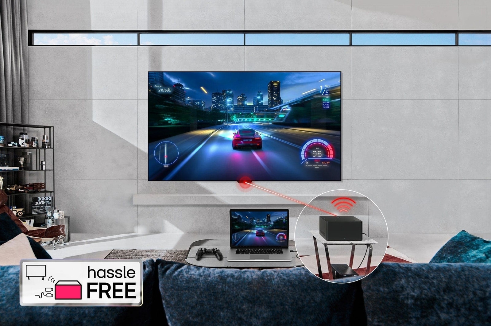 An LG SIGNATURE OLED M4 mounted on a living room wall and a laptop on a table in front displaying the same car racing game. A close-up of a Zero Connect Box on a smaller table, with a console connected underneath and a red Wi-Fi signal and red beam emitting towards the TV. The words "hassle FREE" in the bottom left corner.