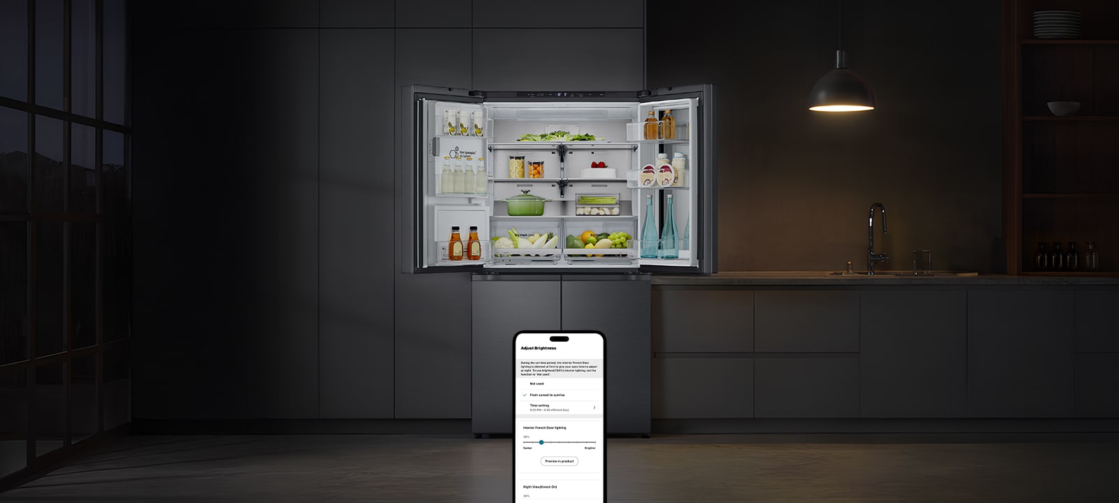 Dark kitchen with a hanging lamp above and an open LG refrigerator revealing organized food inside