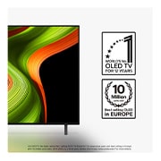 Colorful parrot in ultra-high definition against a black background. Water drops are suspended in the air all around it. The image showcases Perfect Color as each different hue on the parrot's body is vibrant and vivid. The dark background with the detailed water splashes also highlights how the screen is reflection-free. Different logo certifications from UL and Intertek are visible. These refer