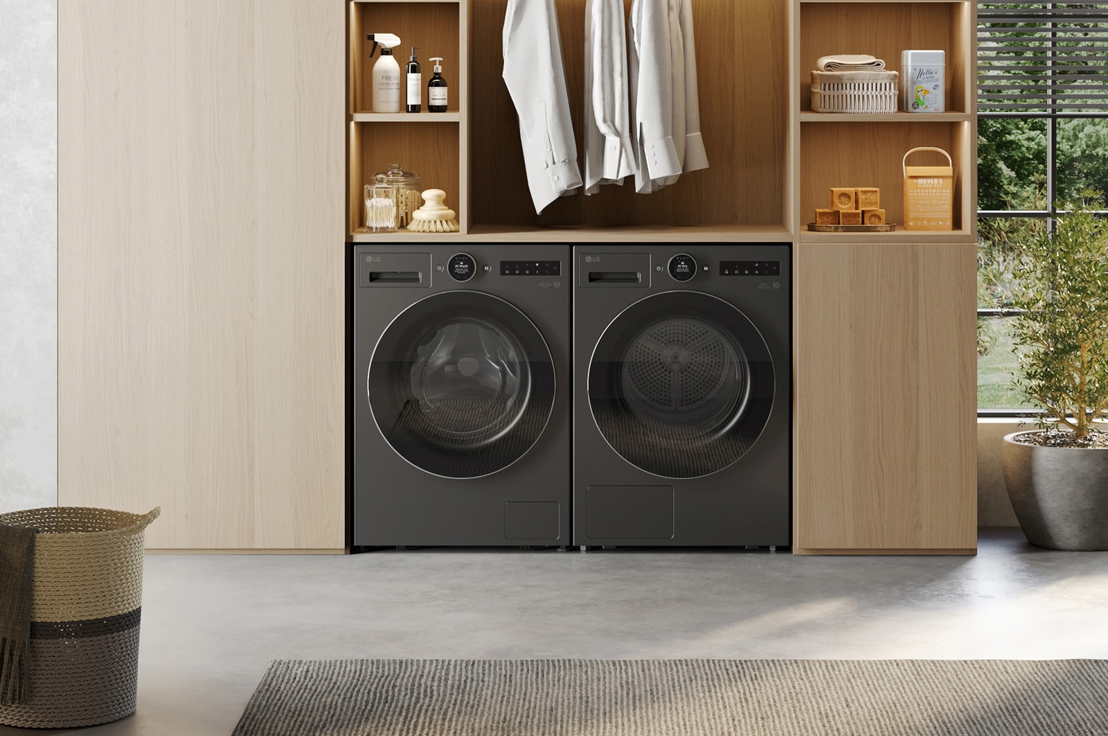 This lifestyle image shows LG RHX7010TBB 10 10kg DUAL Inverter Heat Pump™ Dryer, Black, along side an LG Laundry machine in black, the environment looks nice and cozy with natural colour theme