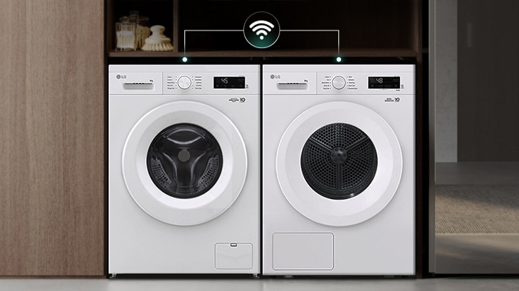 LG washing machine and dryer set, white, side by side, with Wi-Fi connectivity in a wooden cabinet. LG washing machine and dryer set, white, side by side, with Wi-Fi connectivity in a wooden cabinet.