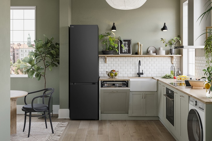 LG Fridge Freezer GBV5240CEP in Essence Matte Black, 203 cm tall, seamlessly integrated into a modern, green-toned kitchen, showcasing its elegant Flat Door design.
