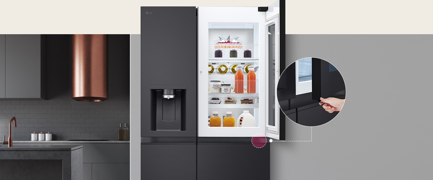 The front view of a black InstaView refrigerator. The door-in-door of the refrigerator is open. There's a small screen that explains where a concealed opening button is to open the door.