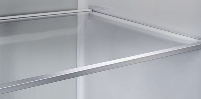 A diagonal view of the shelf with metallic paneling on the interior of the refrigerator.