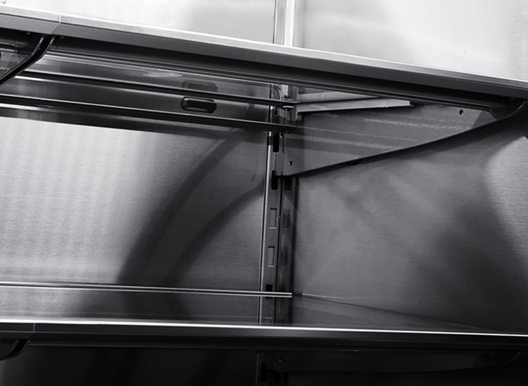 Close horizontal shot of the stainless inner walls of LG SIGNATURE Refrigerator.