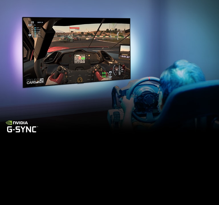 Man sitting on a racer gaming chair, holding a racing wheel while playing a racing game on a TV screen