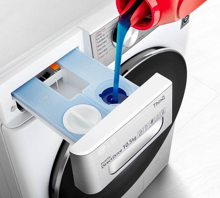 Detergent is pouring into the washing machine's detergent container.