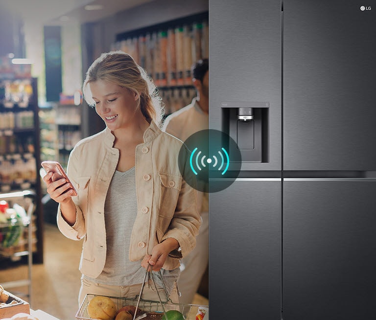 Image on the left shows a woman standing in a grocery store looking at her phone. Image on the right shows the refrigerator front view. In the center of the images is an icon to show connectivity between the phone and refrigerator.