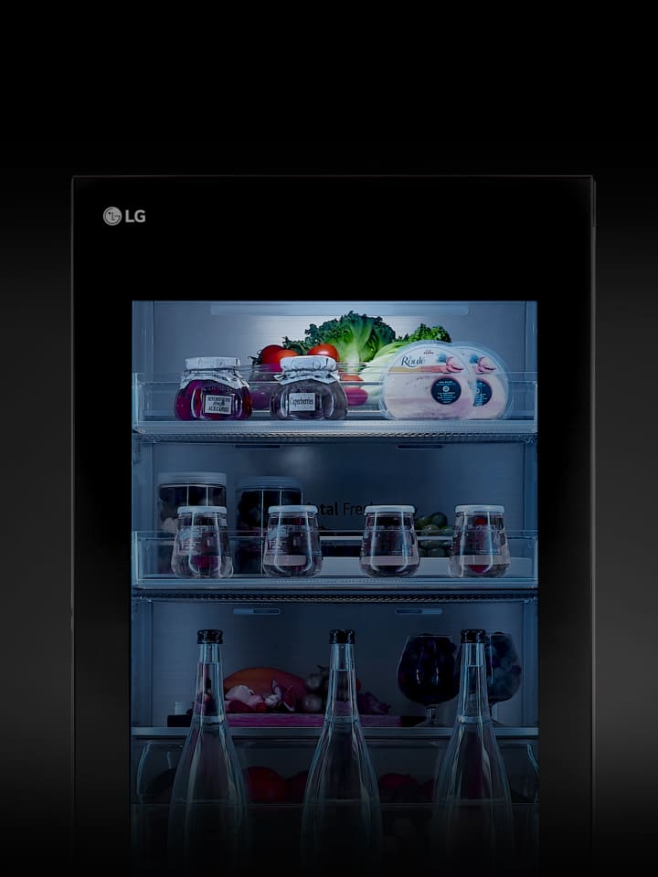 The lights on the instaview exterior of the LG bottom freezer are turned on.	