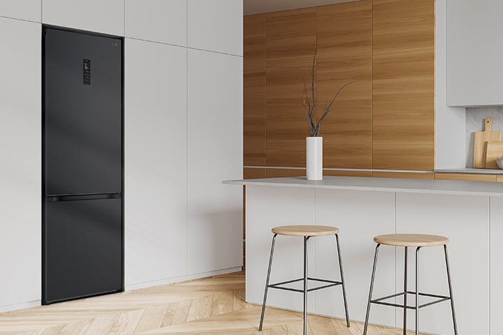 Modern kitchen with a refrigerator that blends seamlessly into surrounding cabinetry, resembling a built-in model.