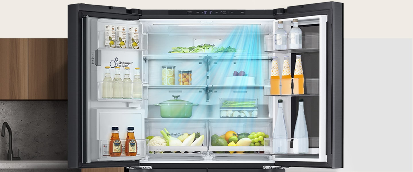 LG fridge with doors open, showcasing drinks on the right and fruits and vegetables on shelves inside.
